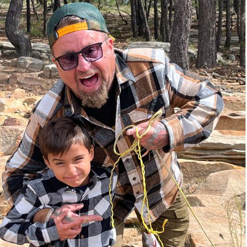 Kolby and his son fishing among the pines